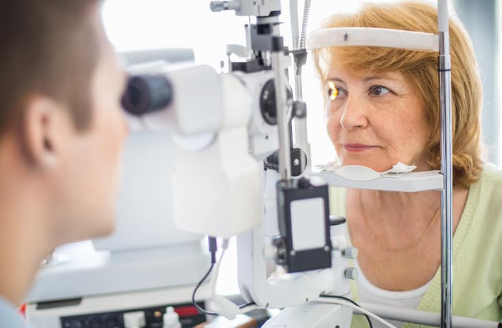 Senior woman visiting optician.