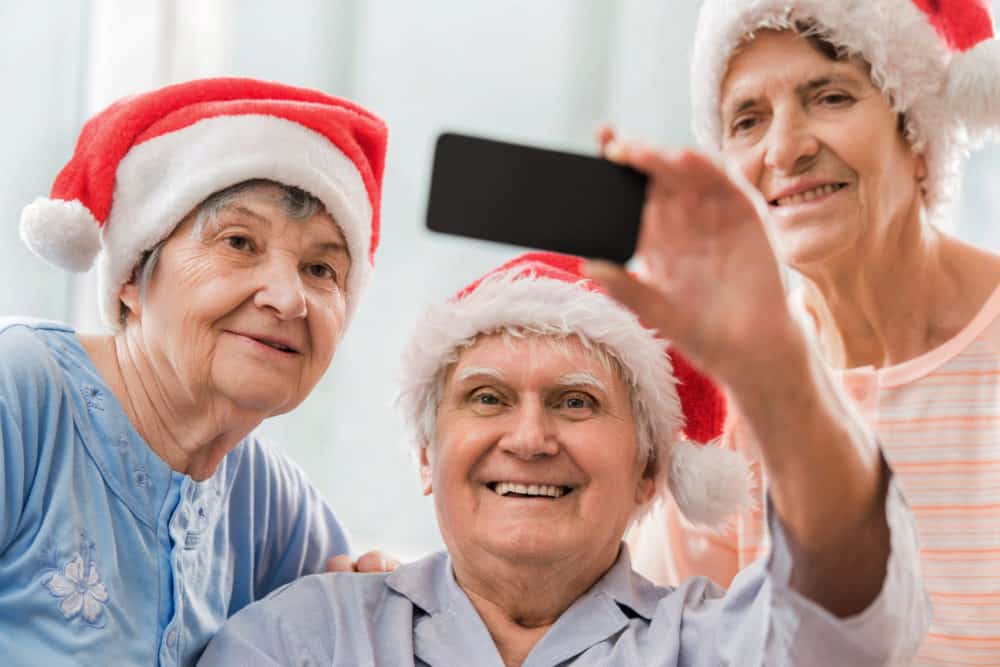 Happy senior people taking selfie during winter holidays.