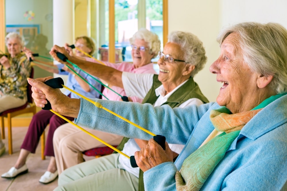 Elderly ladies exercising in a gym.