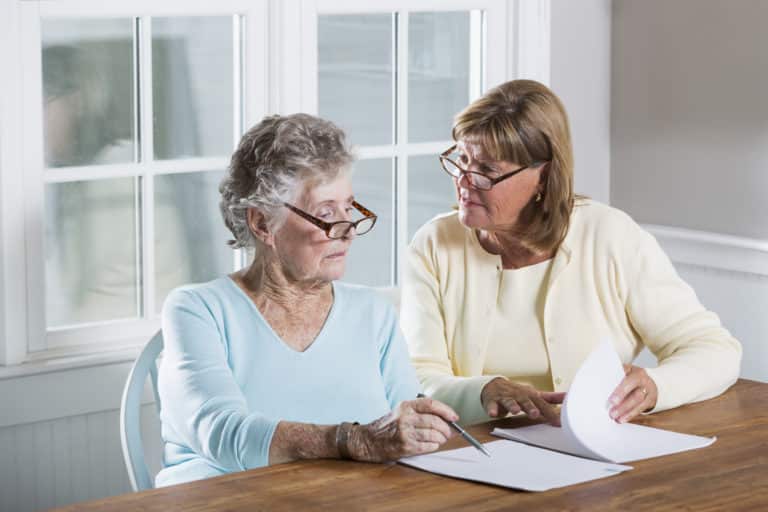 Elderly woman reading paperwork
