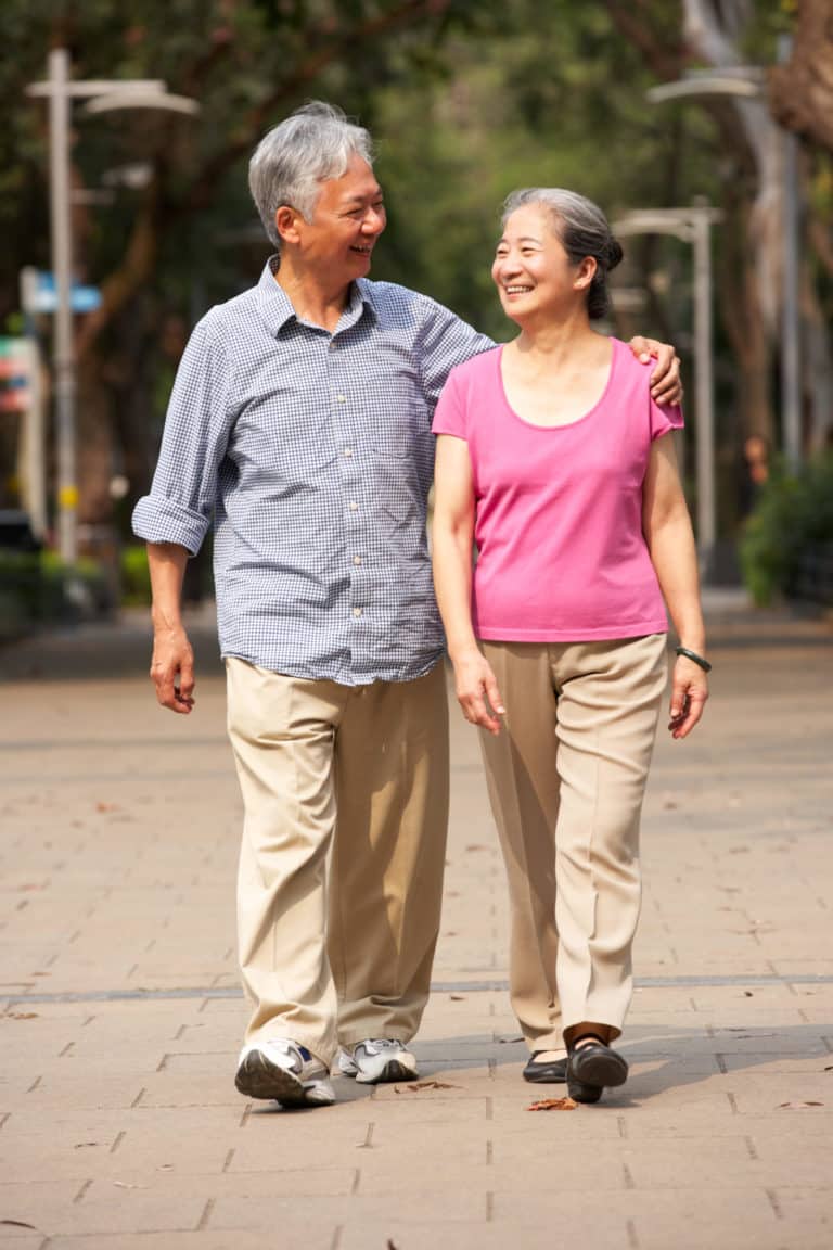 A senior couple taking a walk in the park
