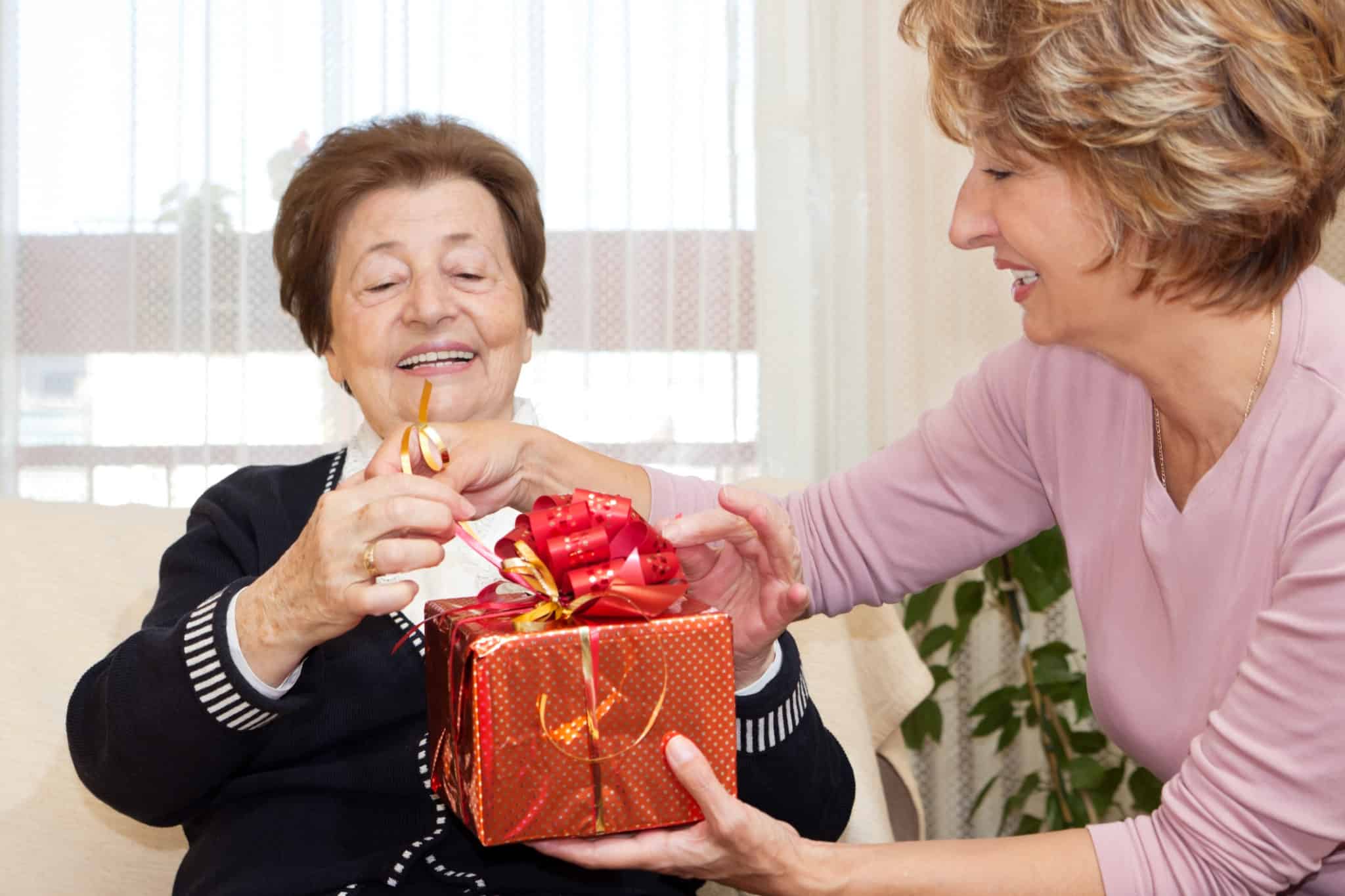 An elderly woman receiving a gift