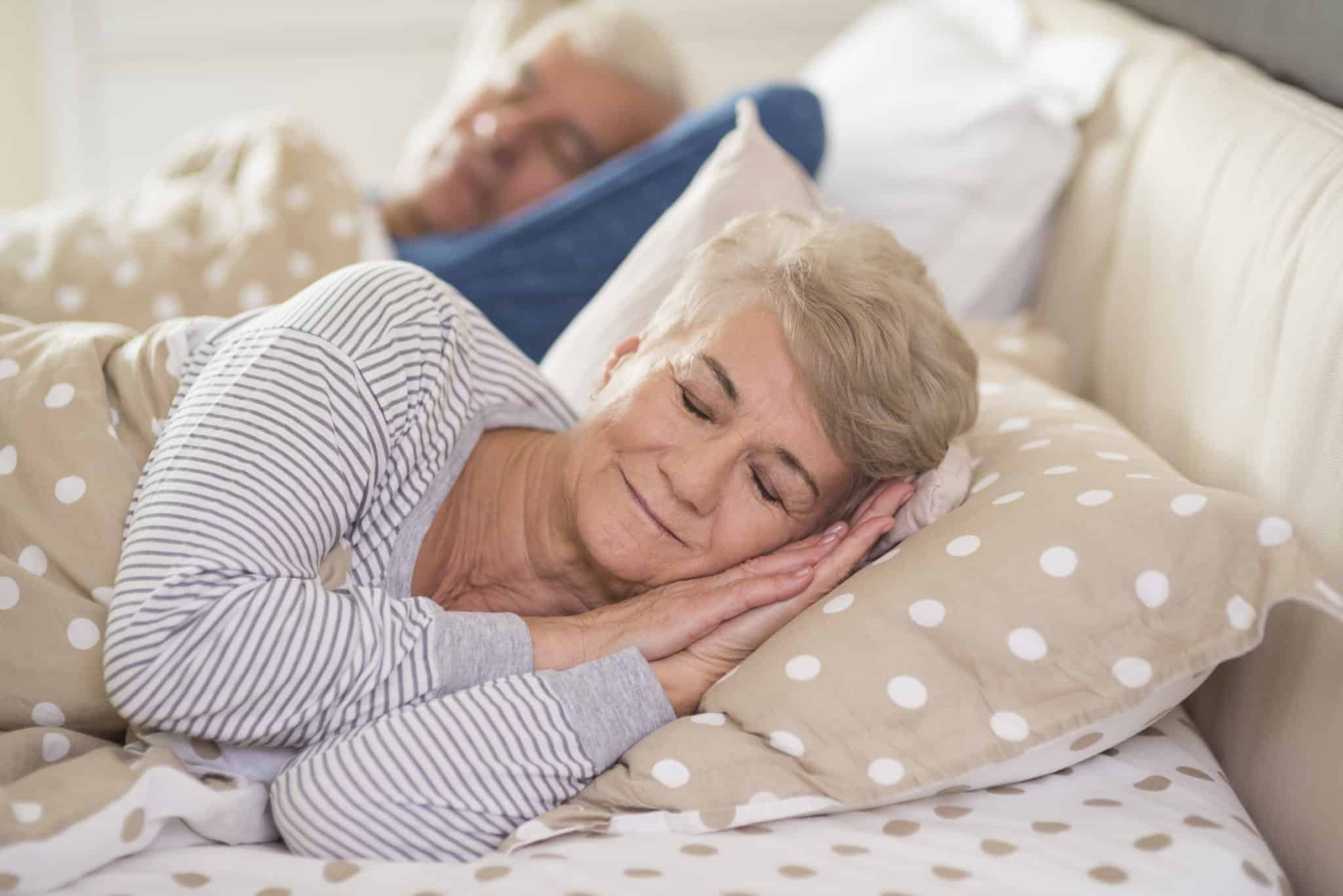Woman and her husband sleeping comfortably