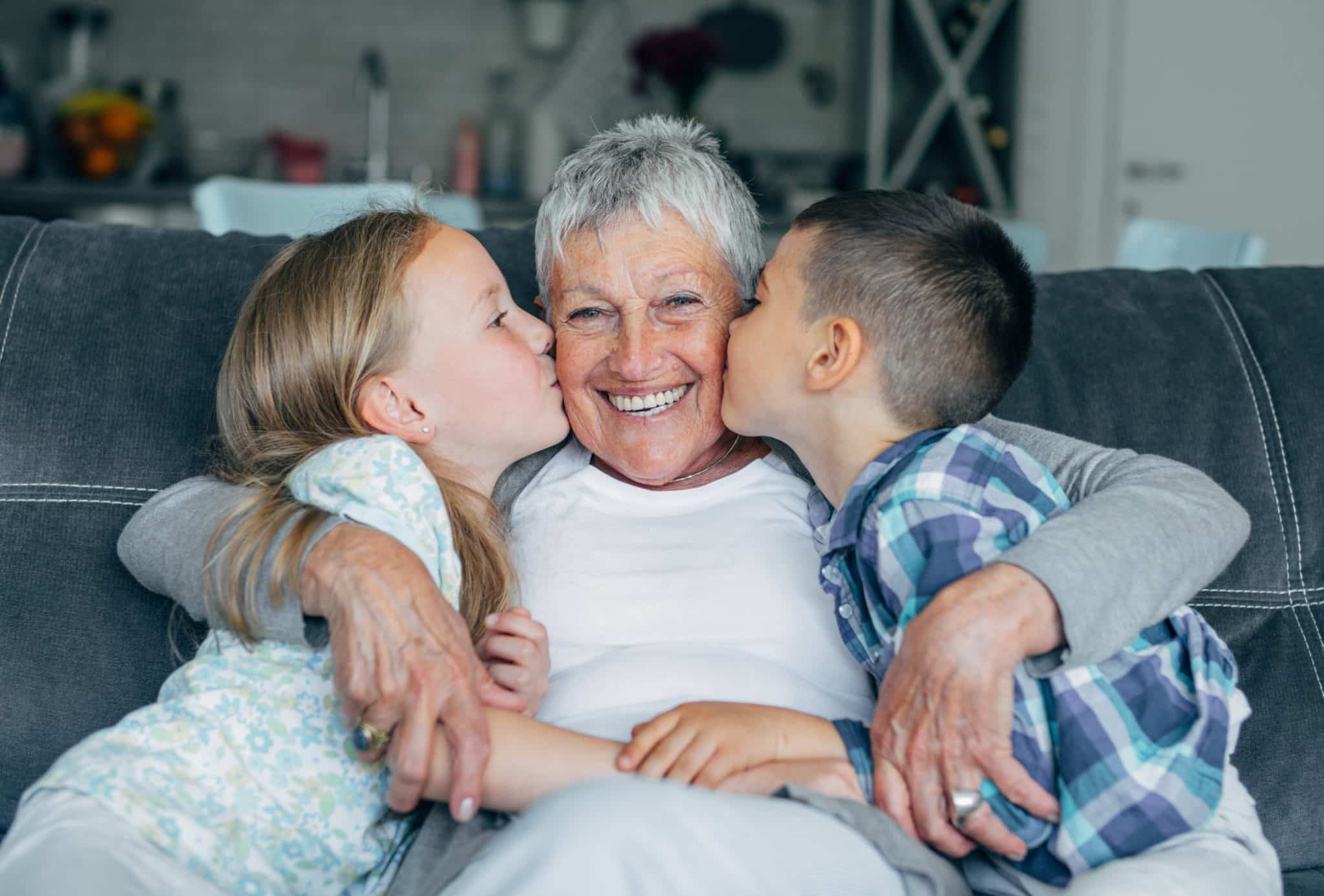 Lovely kids kissing their grandmother