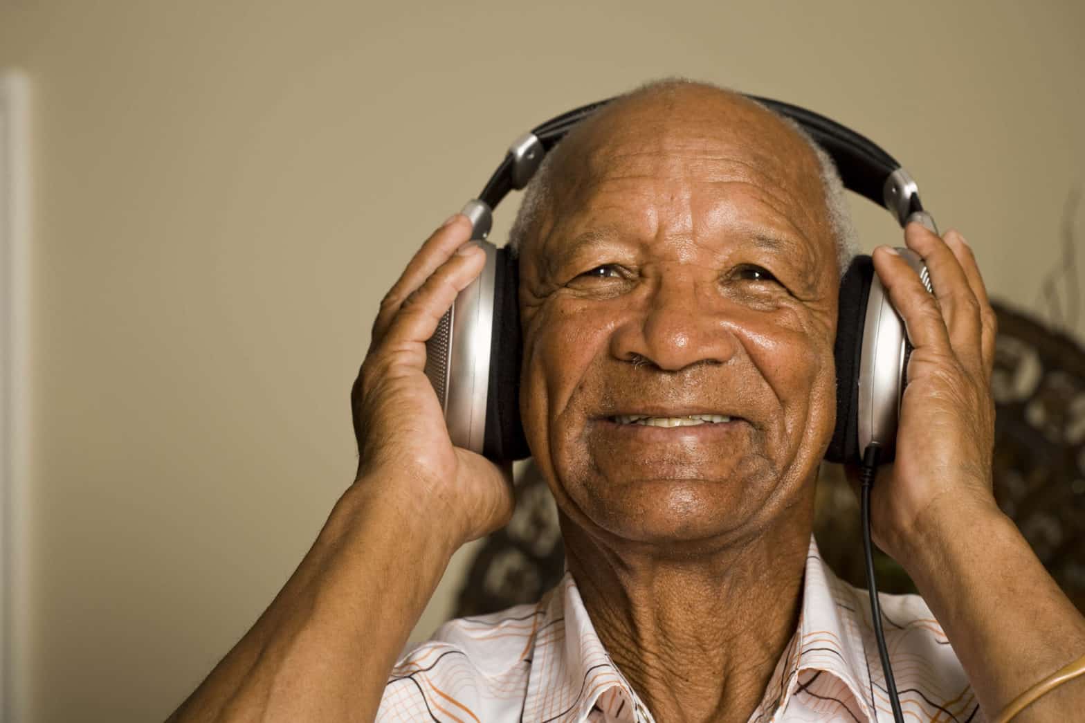 Senior man listening to headphones