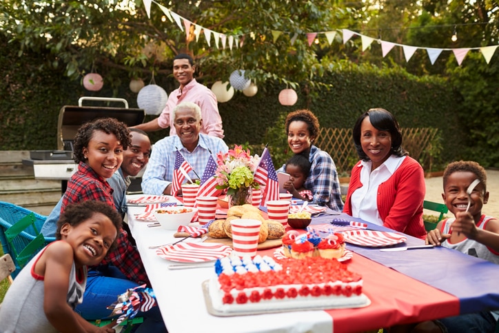 Multi generation black family having a 4th July garden party