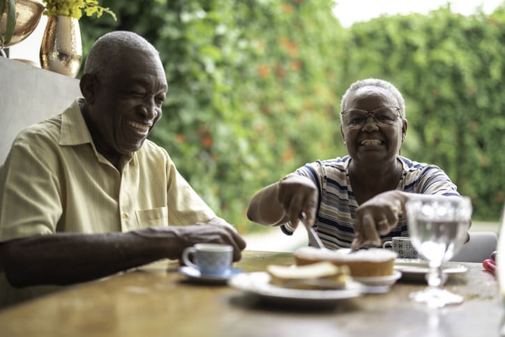 Happy african senior couple having breakfast