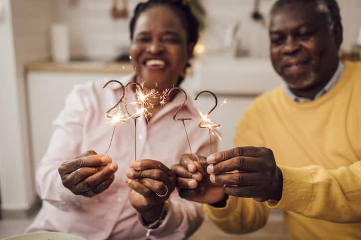 Senior African American couple lighting sprinklers for the 2022 New Year's Eve