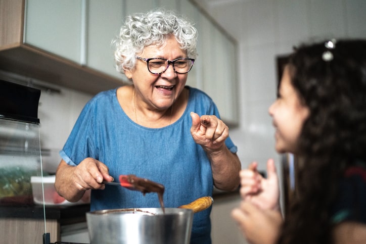 Grandmother making chocolate with granddaughter at home