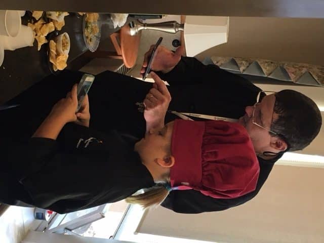 Corrine Godlewski and Executive Chef Rich Schleeter use their smart phones to research the next recipe they are going to cook for residents at UMC at Pitman.